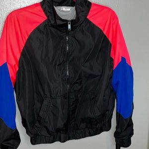 black wind breaker with pink and dark blue sleeves